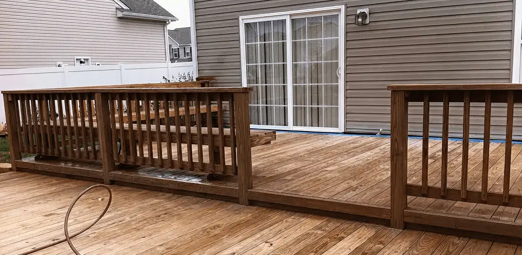Deck sealing service protecting a backyard wood deck and railings in Tallahassee, FL