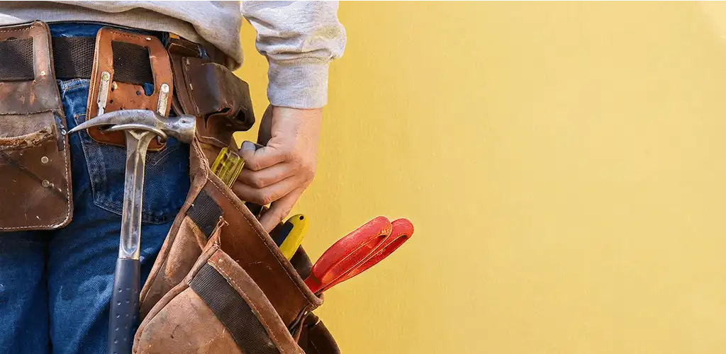 Handyman with tool belt ready for home repairs and maintenance in Tallahassee, FL