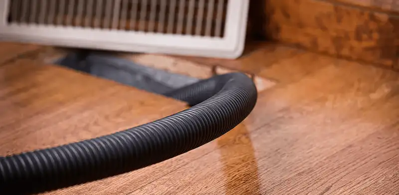 Air duct cleaning hose inserted into a floor vent for ductwork cleaning in Tallahassee, FL