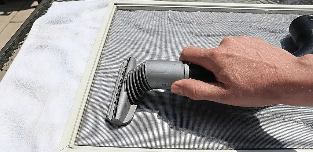 Window screen repair cleaning and fixing a damaged screen mesh in Tallahassee, FL
